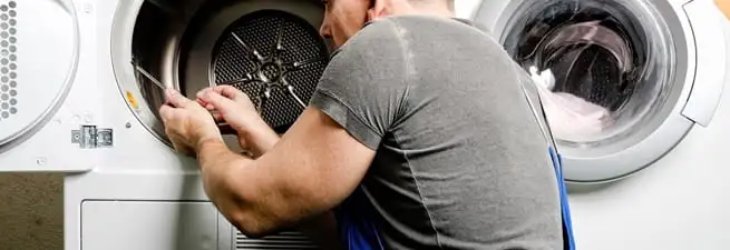 Dryer repair technician fixing a clothes dryer drum in Nashville, TN