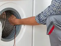 Dryer repair technician diagnosing and servicing a clothes dryer in Nashville, TN