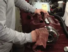 Vacuum repair technician cleaning and servicing a vacuum motor in Nashville, TN